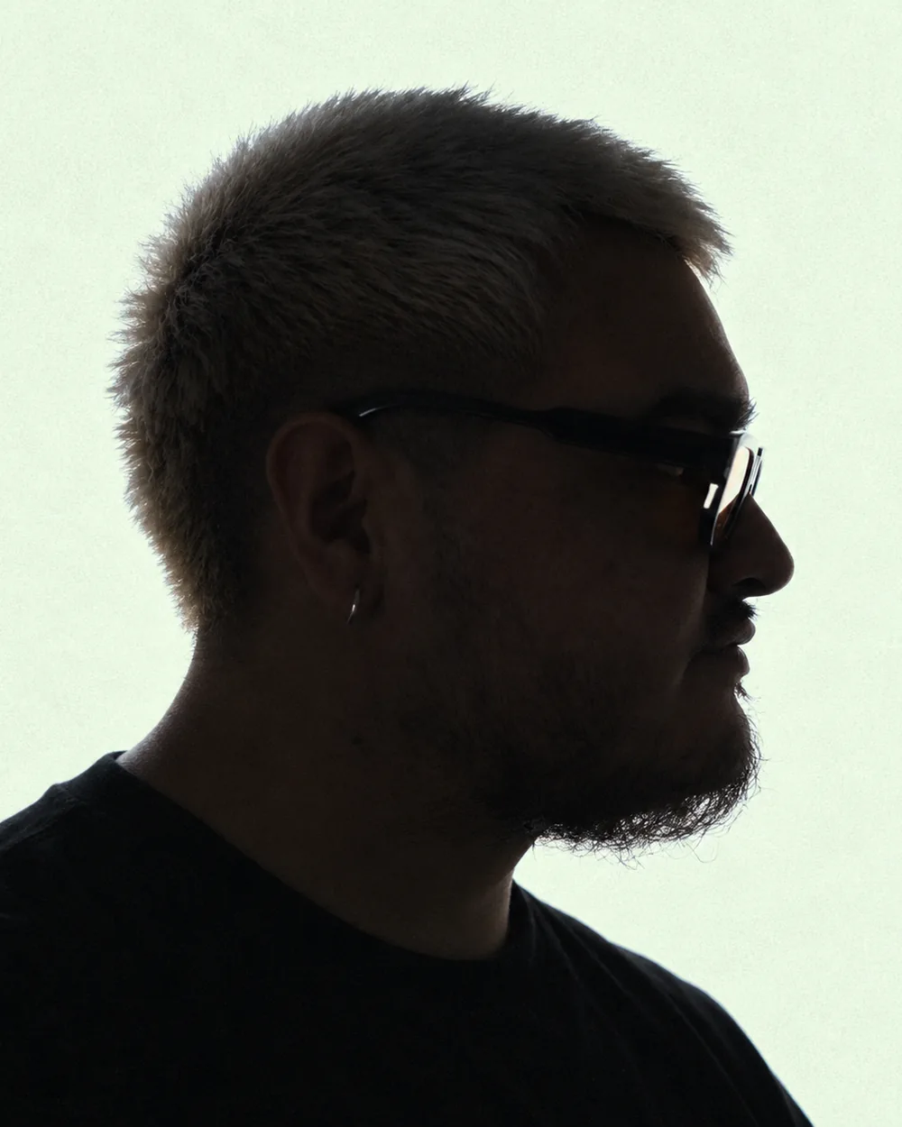 Kenny Palacios in silhouette, in profile